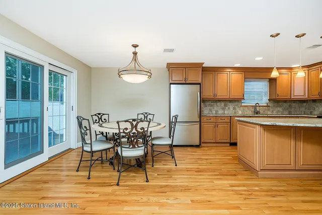 a view of a kitchen with dining table and chairs