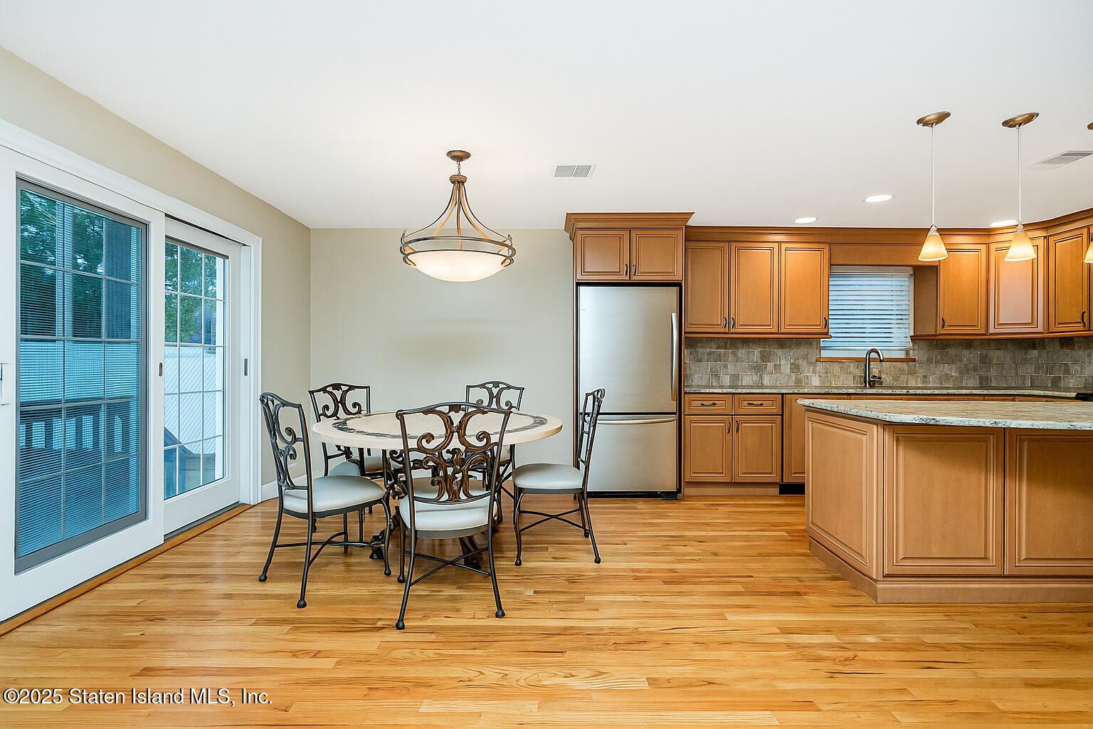 145 Shirley Avenue Staten Island, NY 10312 - Photo 8 of 29 a view of a kitchen with dining table and chairs