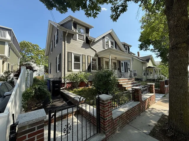 a view of a house with backyard and sitting area