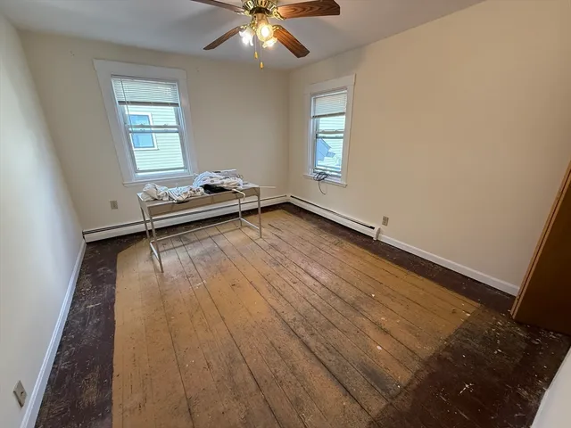 a room with wooden floor and window
