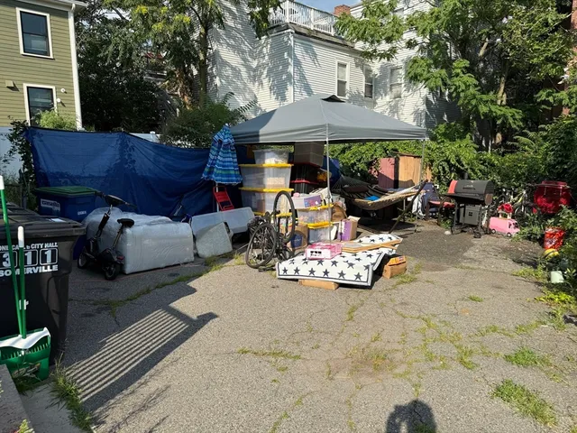 a view of a patio with a table and chairs under an umbrella