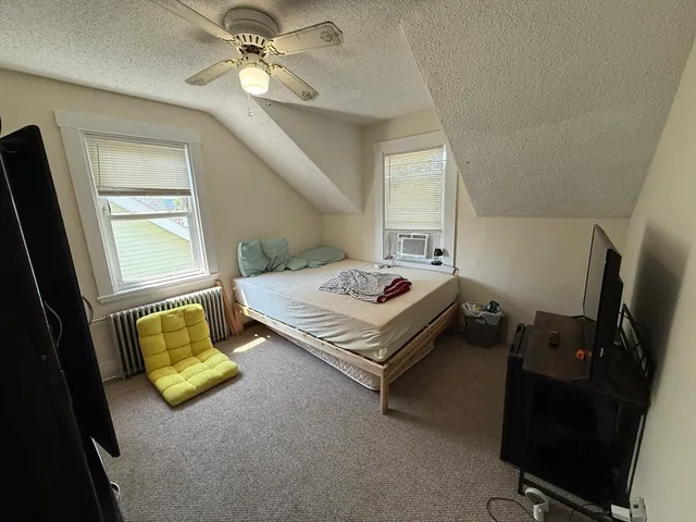a bedroom with bed and a chandelier