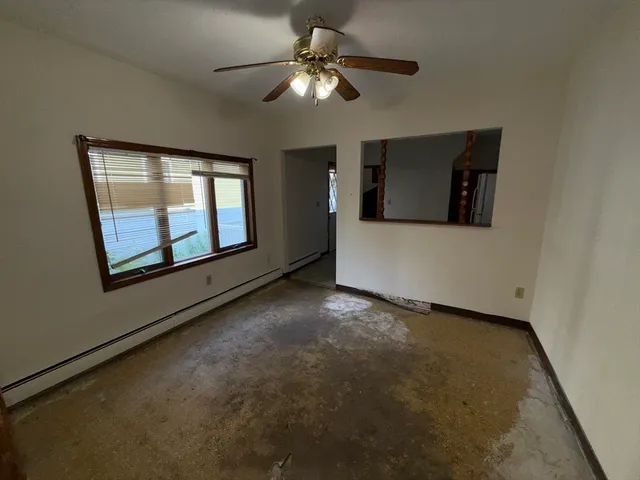 a view of a livingroom with a ceiling fan and window