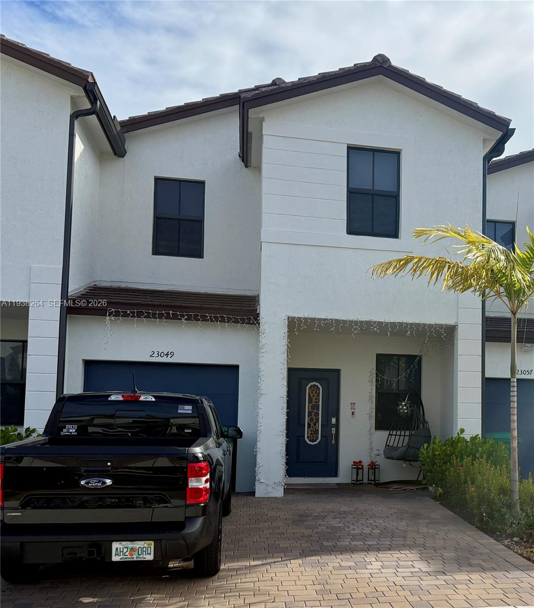 23049 Southwest 129th Place Miami, FL 33177 - Photo 2 of 29 a black car parked in front of a house