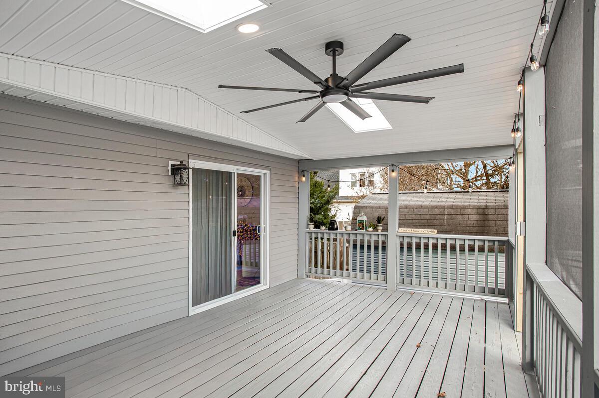 267 Lake Riviera Road Pasadena, MD 21122 - Photo 12 of 34 an empty room with wooden floor and windows