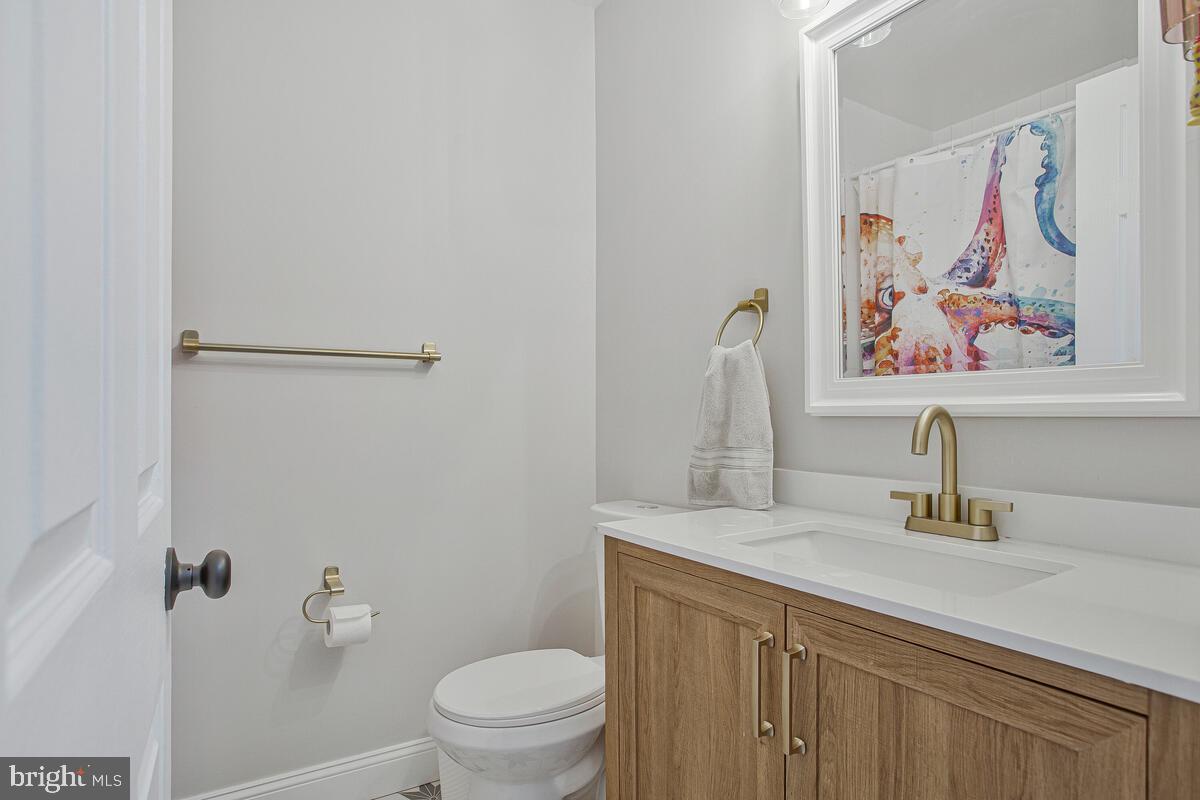 267 Lake Riviera Road Pasadena, MD 21122 - Photo 14 of 34 a bathroom with a sink a toilet and a mirror