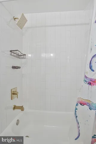 a bathroom with a bathtub and shower