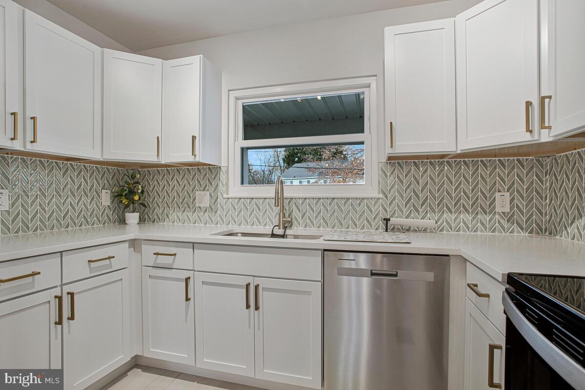 267 Lake Riviera Road Pasadena, MD 21122 - Photo 6 of 34 a kitchen with white cabinets and sink