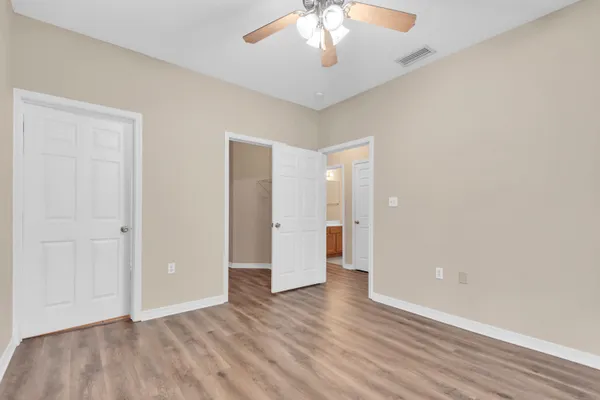 a view of an empty room with wooden floor
