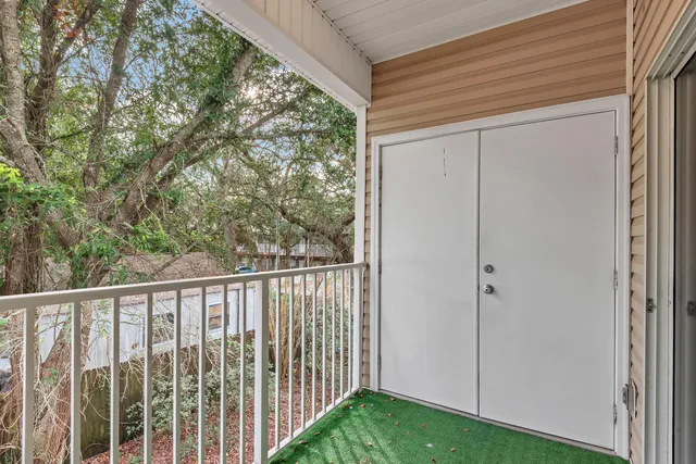 a view of a balcony with yard