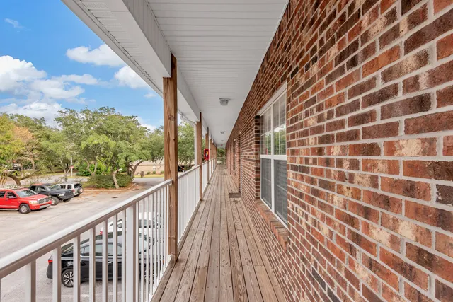 a view of a balcony with wooden floor