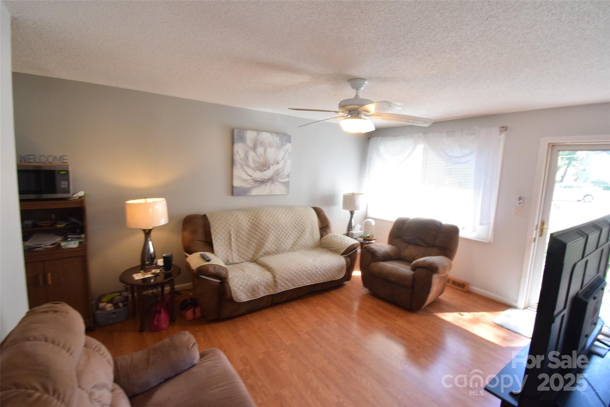 505 Butler Court Gastonia, NC 28054 - Photo 12 of 41 a living room with furniture a fireplace and a flat screen tv