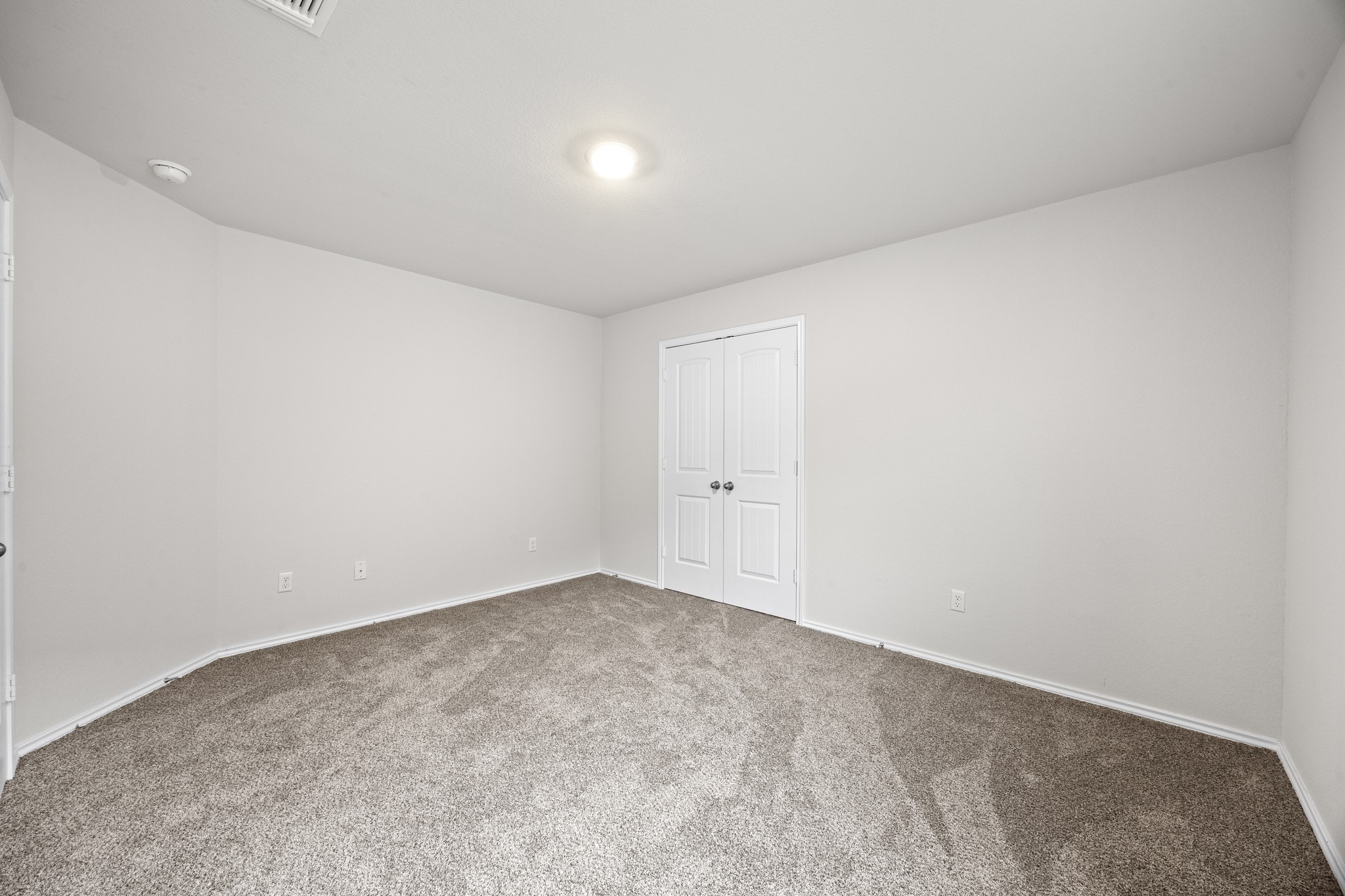 109 Gunther Way Taylor, TX 76574 - Photo 21 of 29 Neutral tone wall paint with plush gray carpeting
