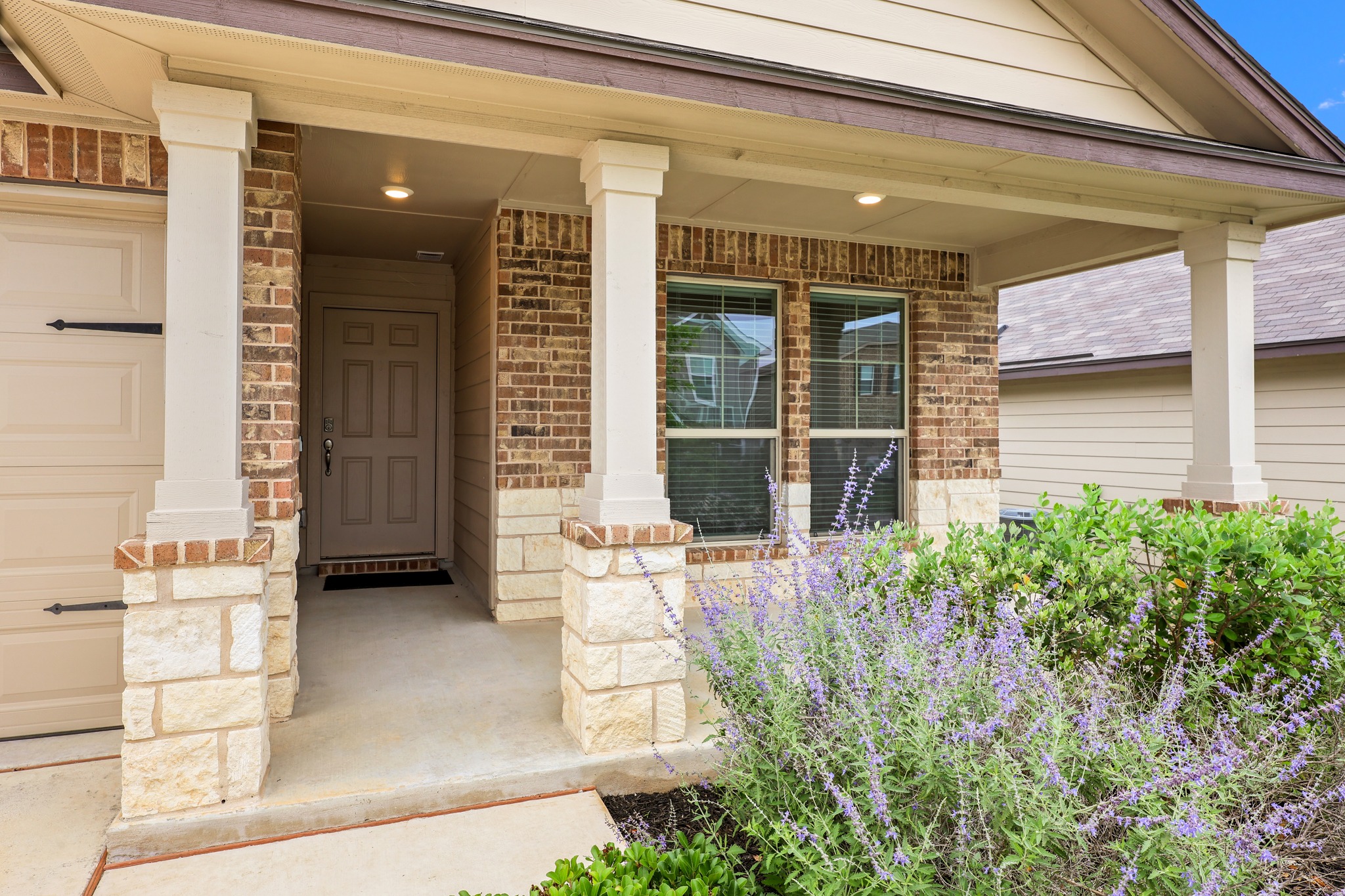 109 Gunther Way Taylor, TX 76574 - Photo 3 of 29 Covered entry featuring brick and stone veneer, multiple paned windows, and a panel front door