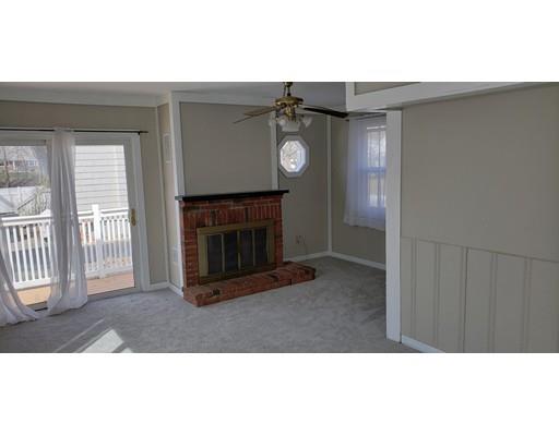 16 Goddard Road Framingham, MA 01702 - Photo 11 of 12 a living room with furniture a window and a fireplace