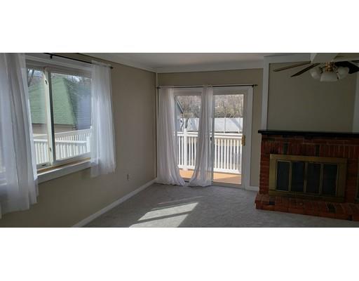 16 Goddard Road Framingham, MA 01702 - Photo 10 of 12 a view of an empty room with wooden floor and a fireplace