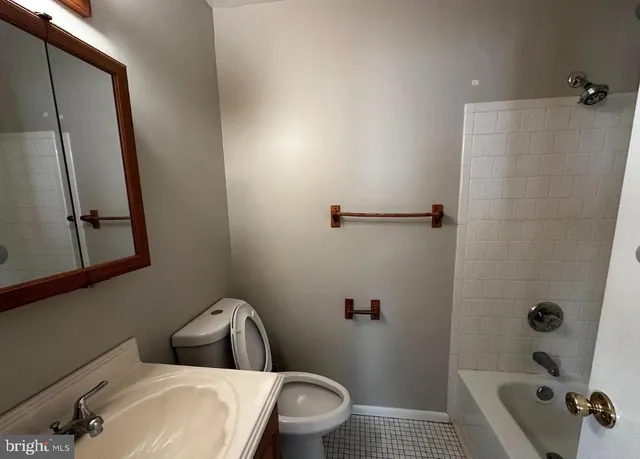 a bathroom with a toilet and a tub