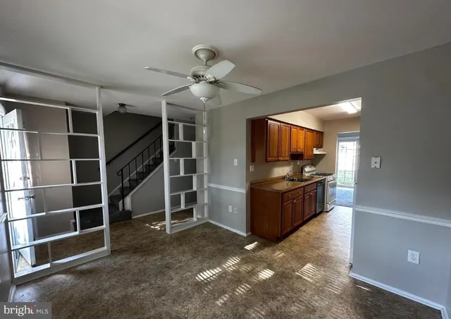 a view of a room with shelves and a ceiling fan
