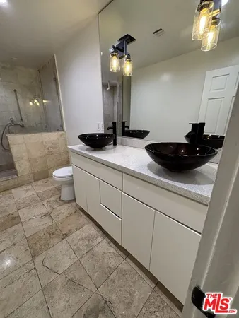 a bathroom with a sink a toilet and mirror