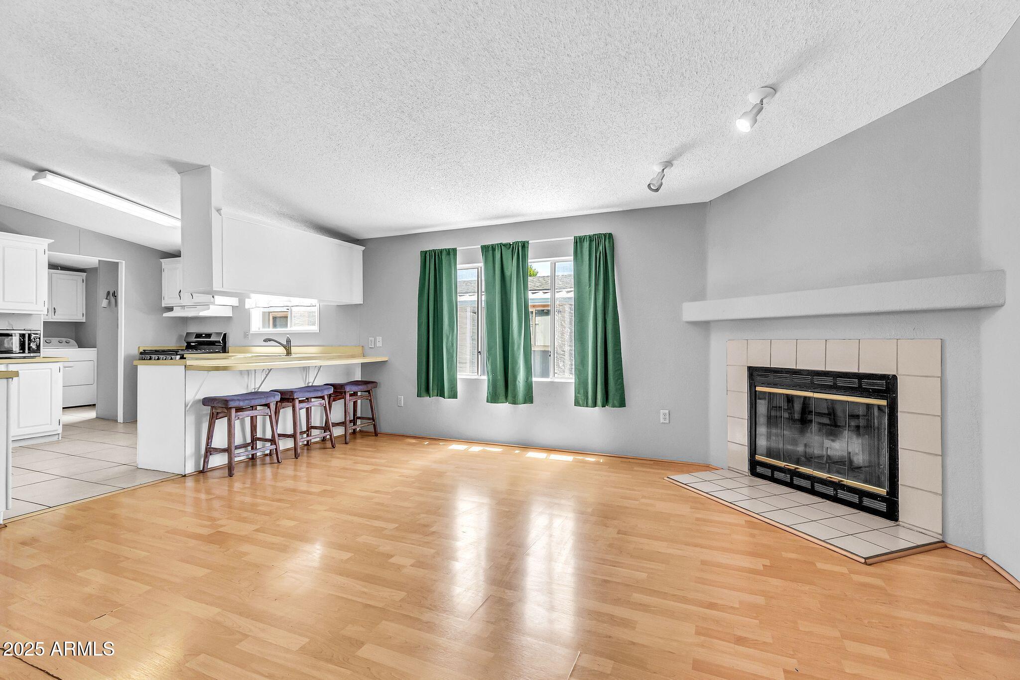 625 West McKellips Road, Unit 399 Mesa, AZ 85201 - Photo 12 of 31 a view of a kitchen with furniture and a fireplace