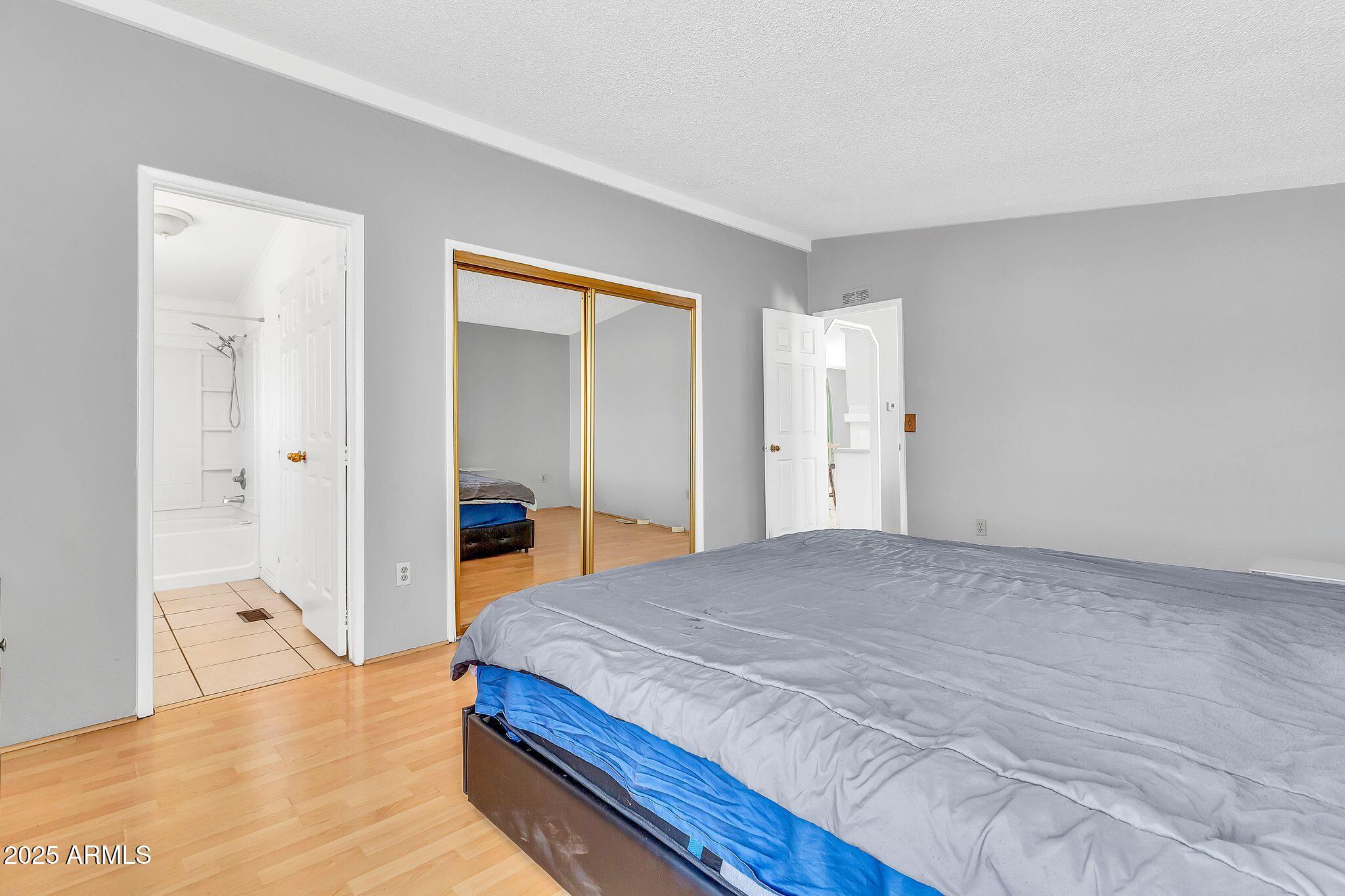 625 West McKellips Road, Unit 399 Mesa, AZ 85201 - Photo 17 of 31 a bedroom with a bed and a mirror