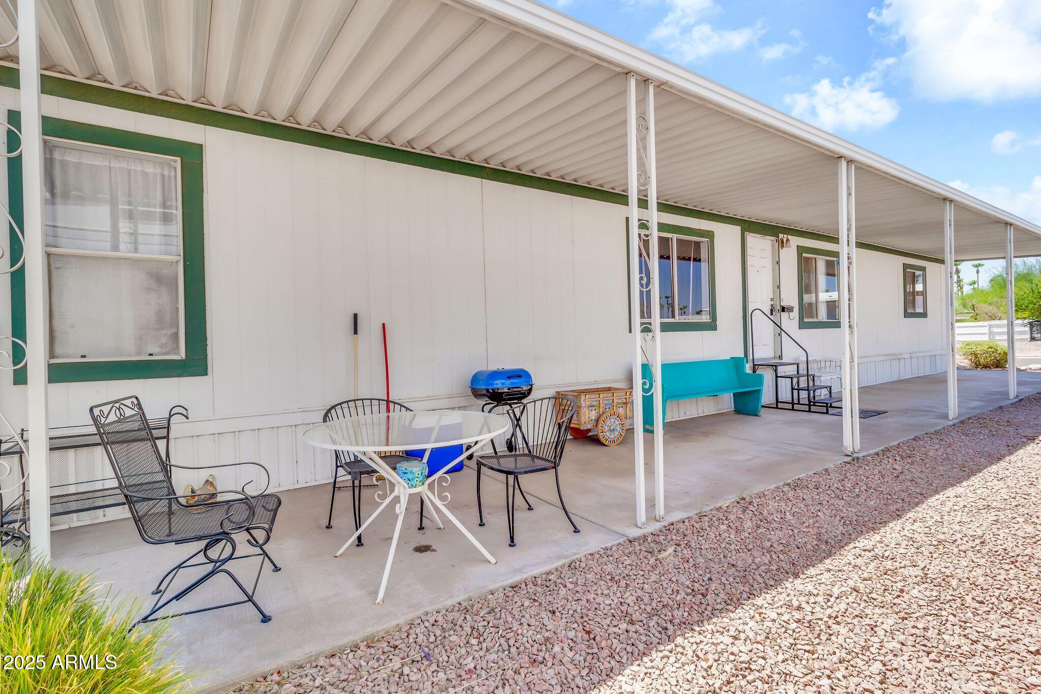 625 West McKellips Road, Unit 399 Mesa, AZ 85201 - Photo 22 of 31 a view of a patio with table and chairs and potted plants