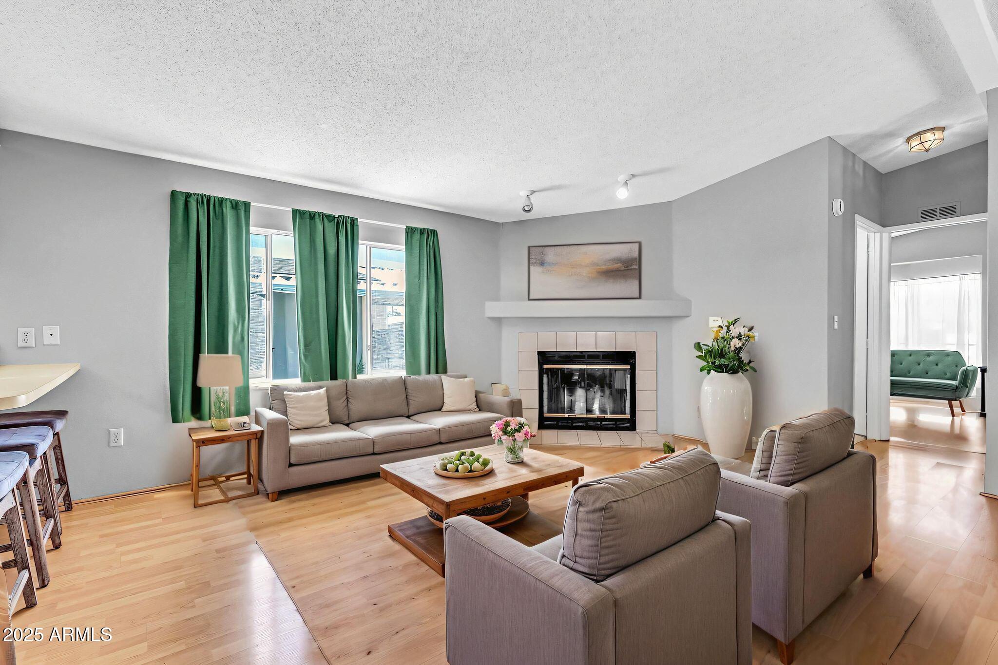 625 West McKellips Road, Unit 399 Mesa, AZ 85201 - Photo 3 of 31 a living room with furniture and a fireplace