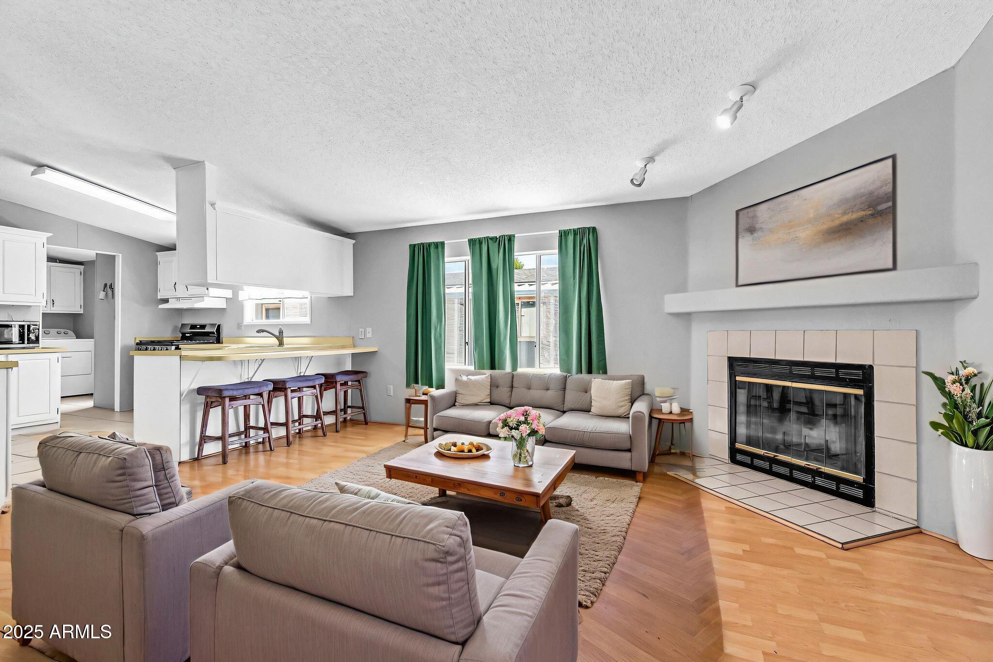 625 West McKellips Road, Unit 399 Mesa, AZ 85201 - Photo 4 of 31 a living room with furniture and a fireplace
