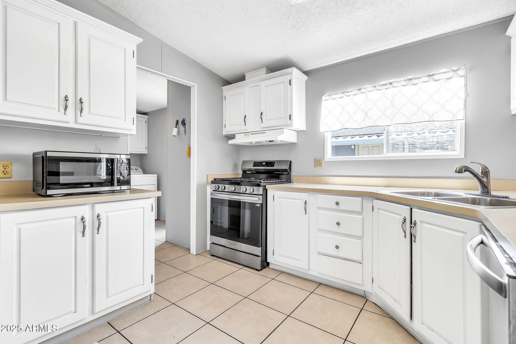625 West McKellips Road, Unit 399 Mesa, AZ 85201 - Photo 8 of 31 a kitchen with white cabinets and white appliances