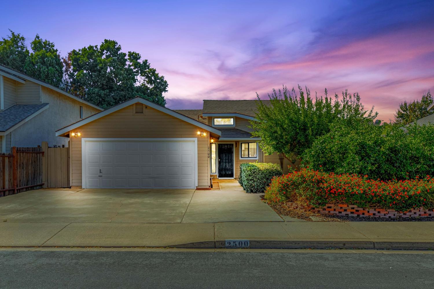 2500 Manor Oak Drive Modesto, CA 95355 - Photo 1 of 1 a front view of a house with a yard and garage