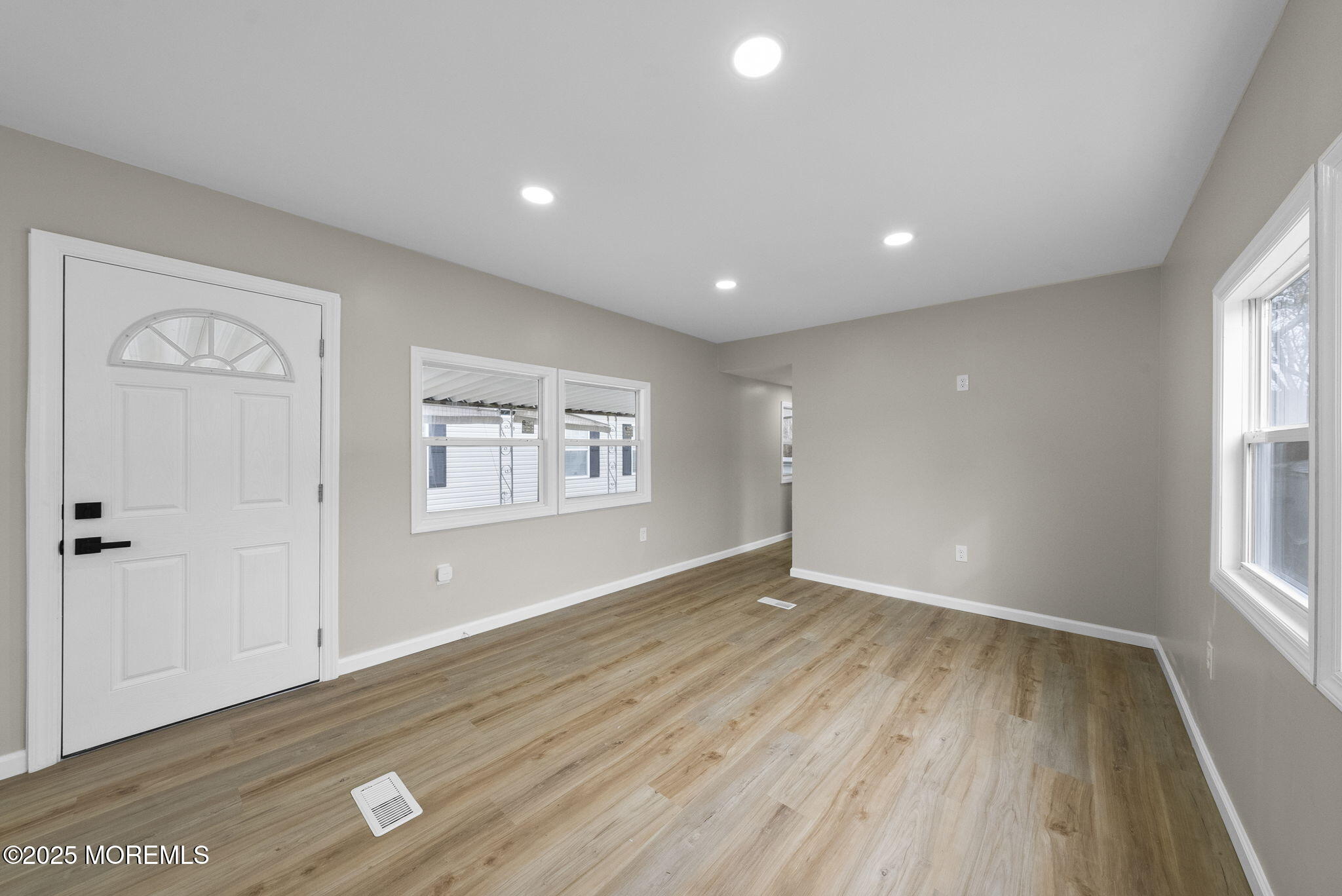 712 7th Street Jackson, NJ 08527 - Photo 13 of 37 an empty room with wooden floor and windows