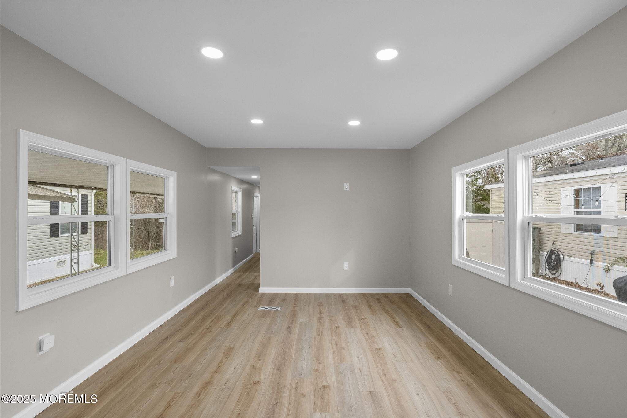 712 7th Street Jackson, NJ 08527 - Photo 14 of 37 a view of an empty room with a window and wooden floor