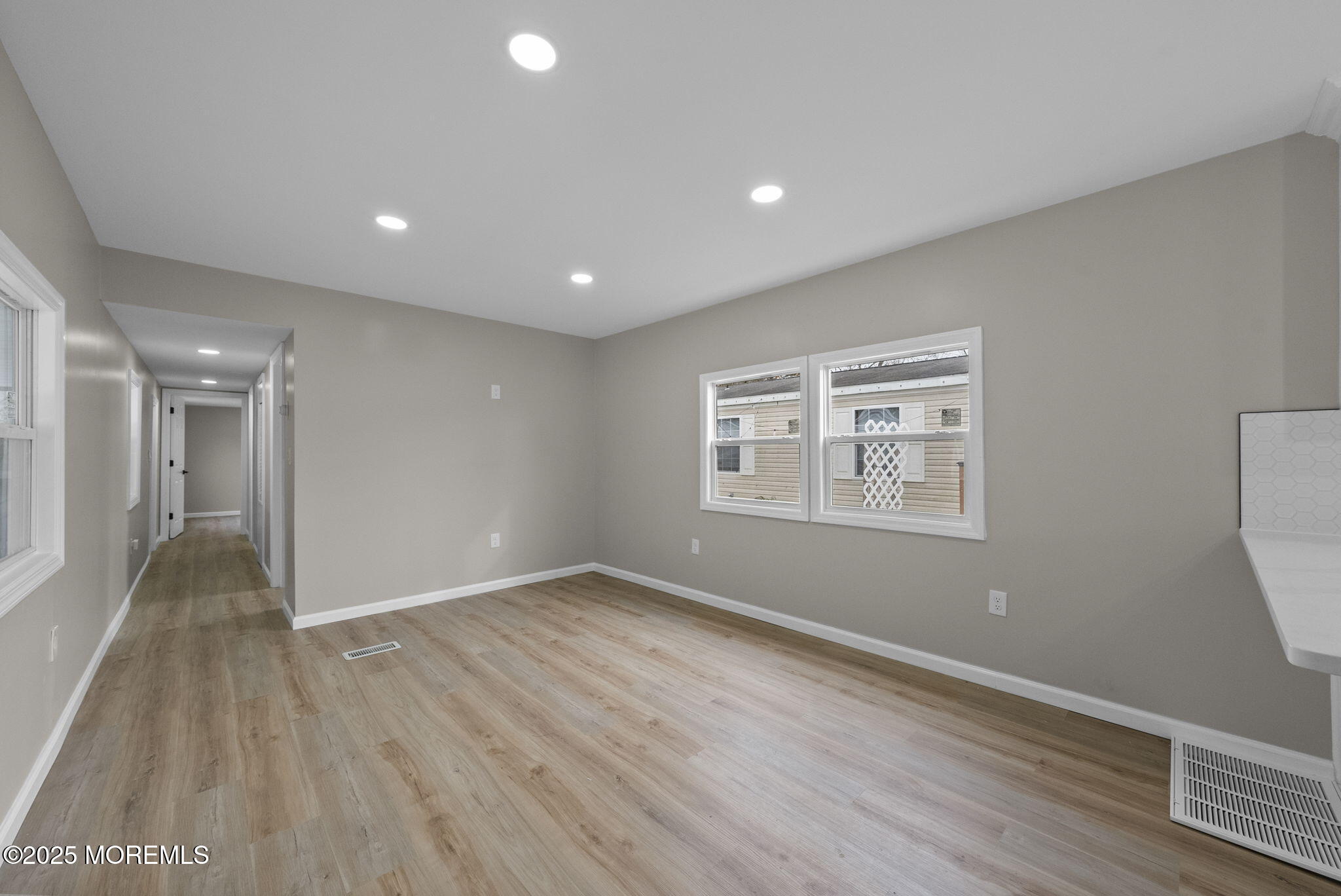 712 7th Street Jackson, NJ 08527 - Photo 15 of 37 a view of an empty room with wooden floor and a window