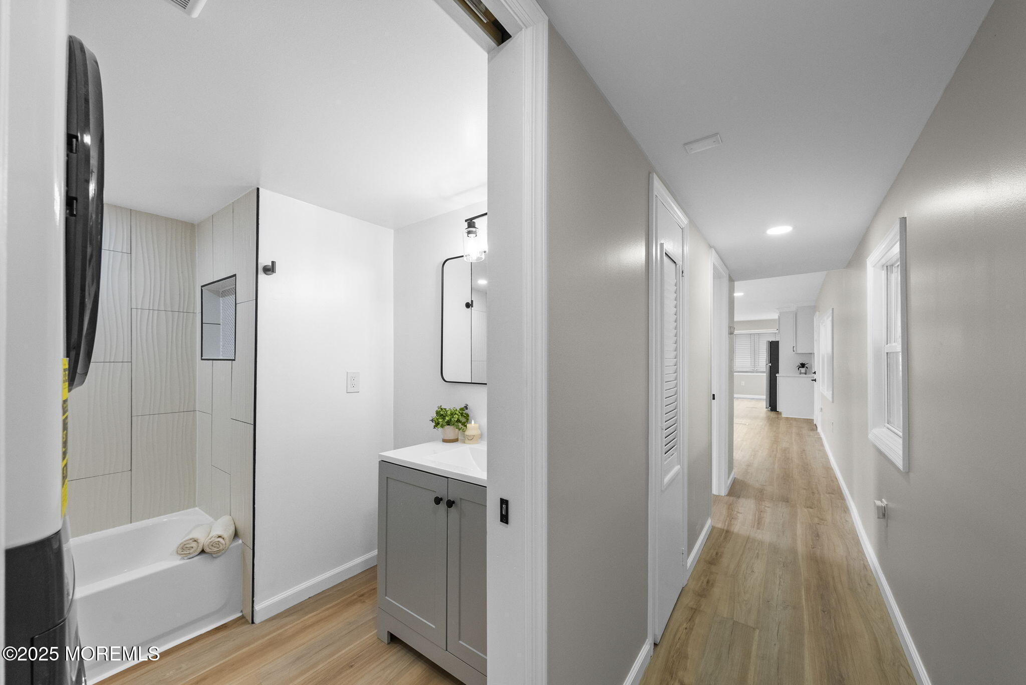712 7th Street Jackson, NJ 08527 - Photo 21 of 37 a view of a hallway with wooden floor and a bathroom