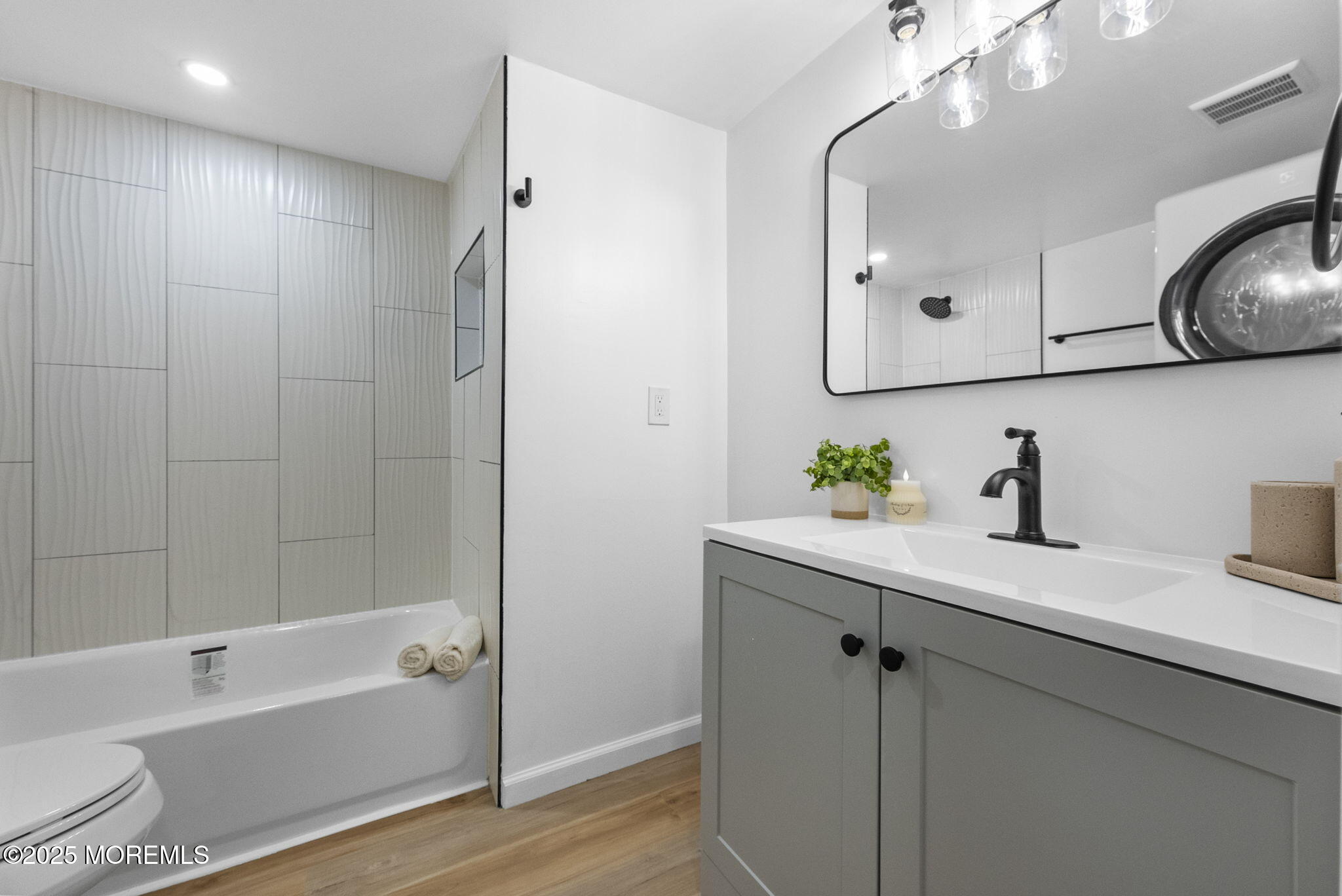 712 7th Street Jackson, NJ 08527 - Photo 22 of 37 a bathroom with a bathtub a sink and a mirror