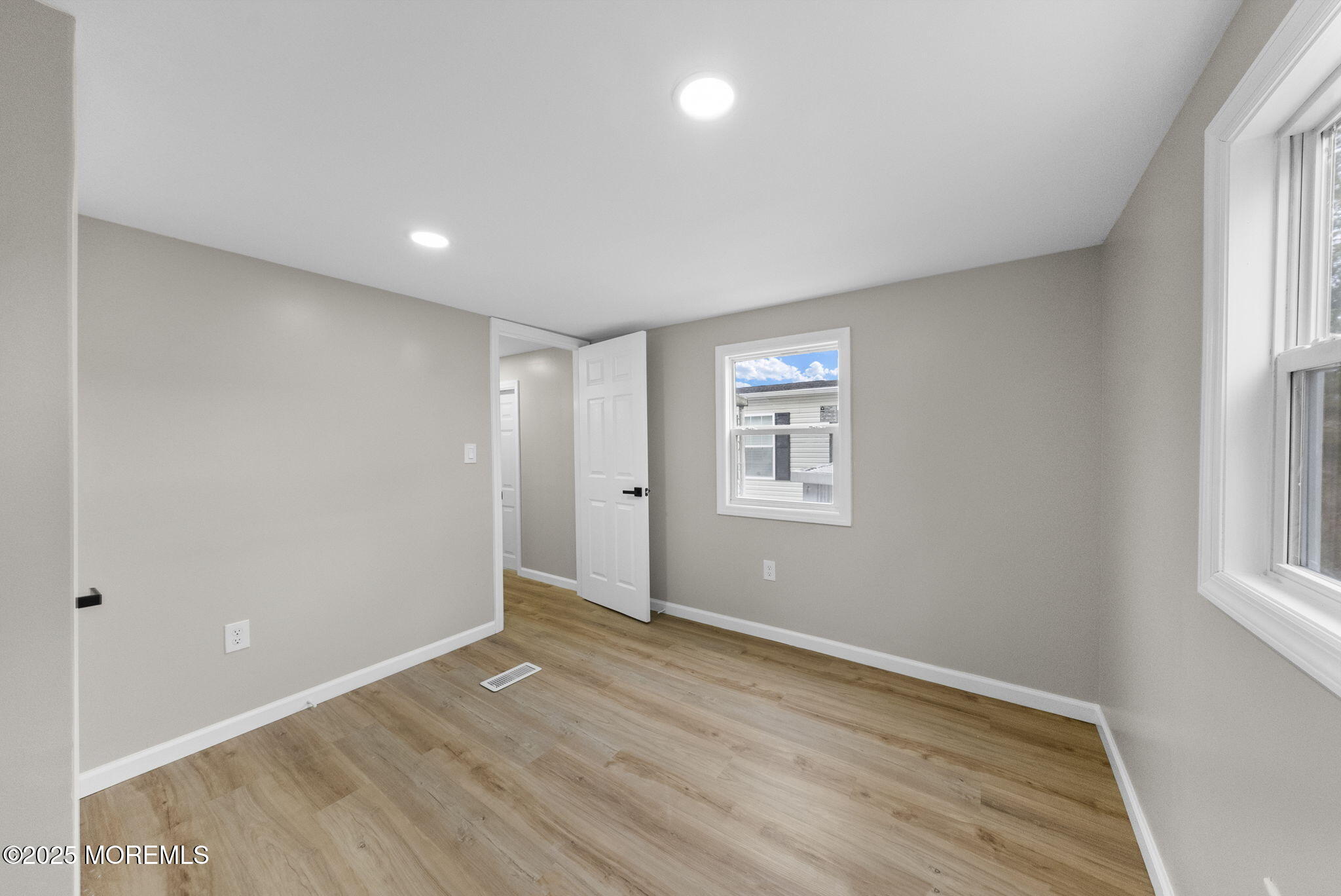712 7th Street Jackson, NJ 08527 - Photo 23 of 37 an empty room with wooden floor and windows