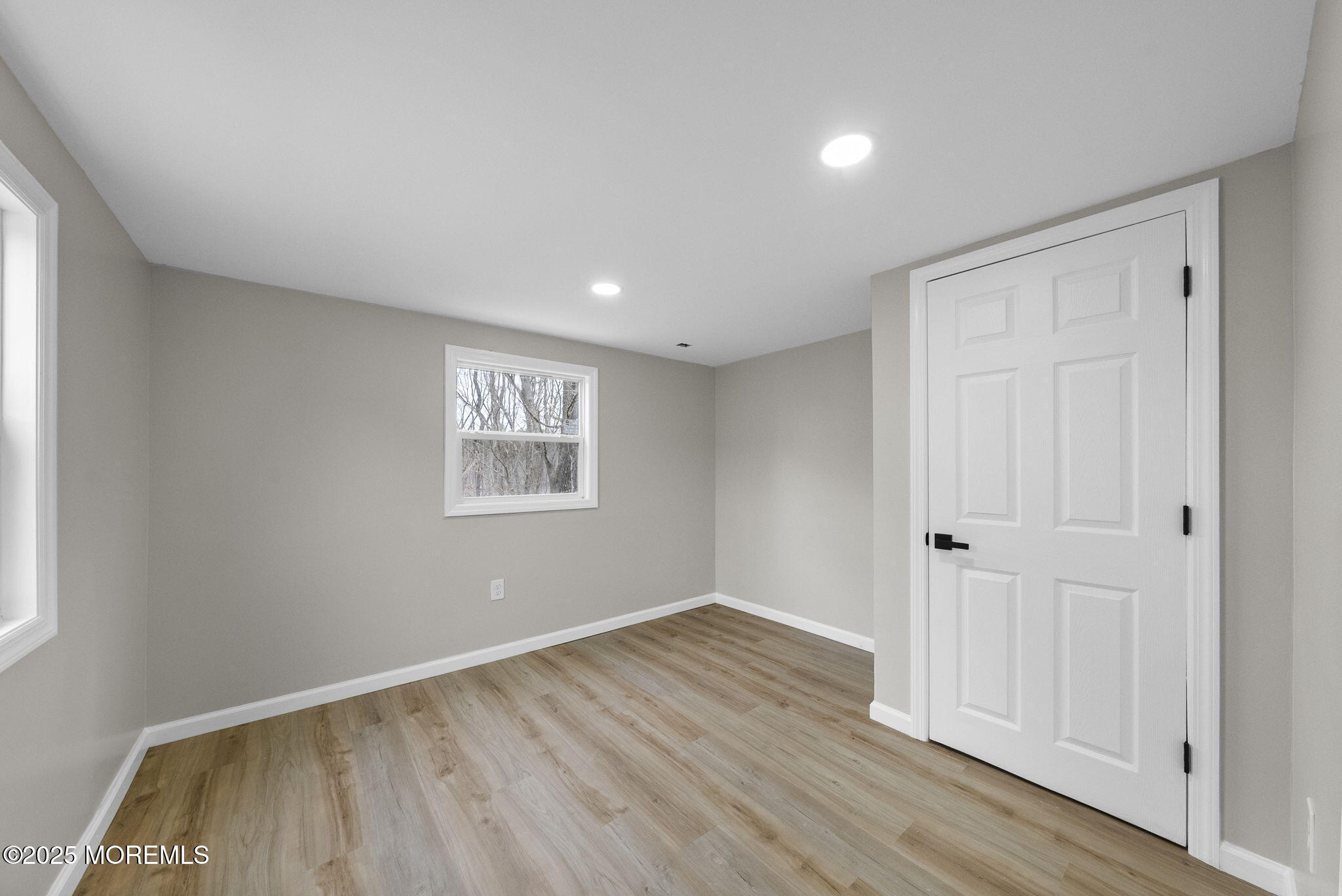 712 7th Street Jackson, NJ 08527 - Photo 25 of 37 a view of an empty room with wooden floor and a window