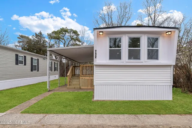a view of a kitchen with wooden floor and a kitchen