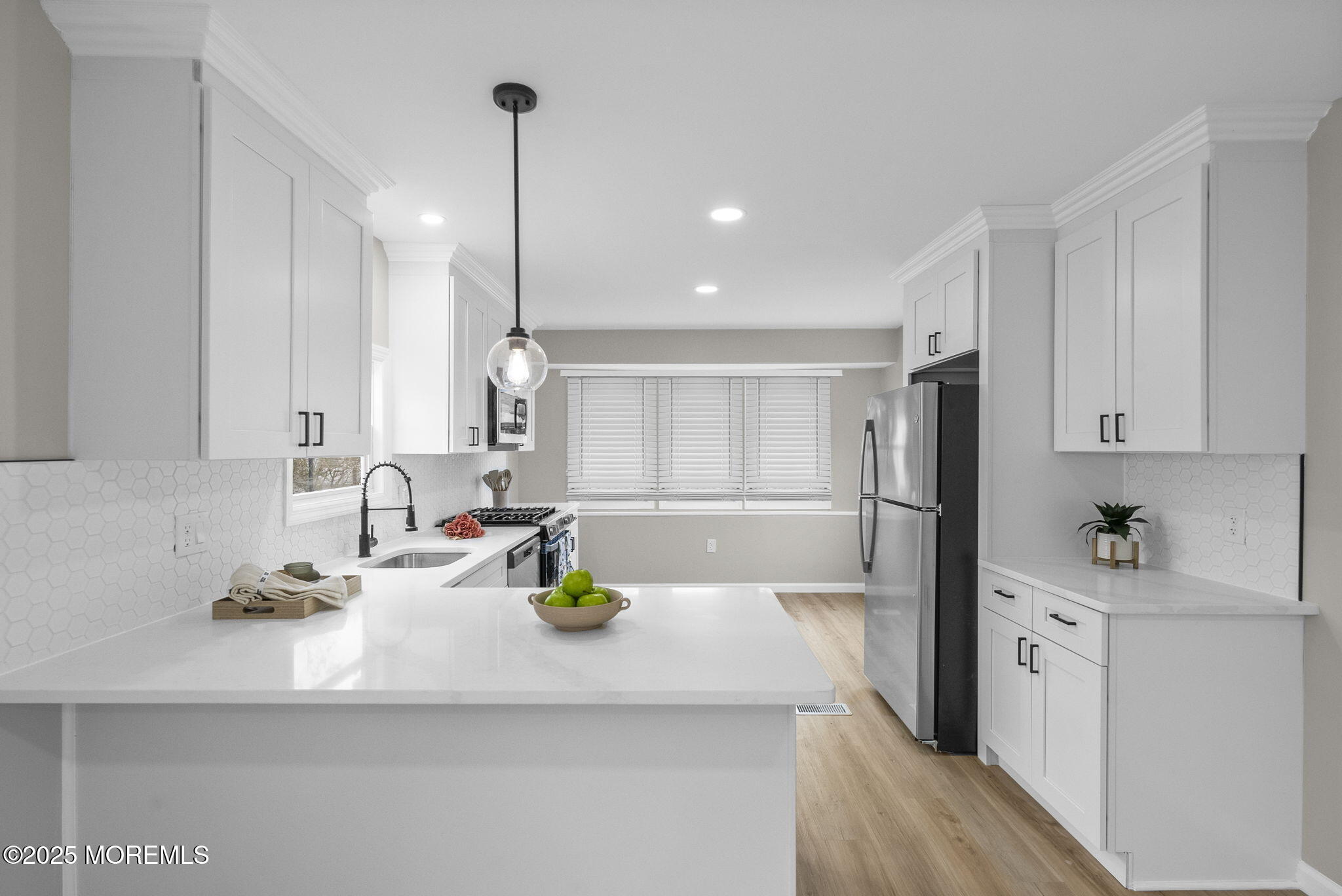 712 7th Street Jackson, NJ 08527 - Photo 8 of 37 a kitchen with stainless steel appliances a sink a refrigerator white cabinets and wooden floor