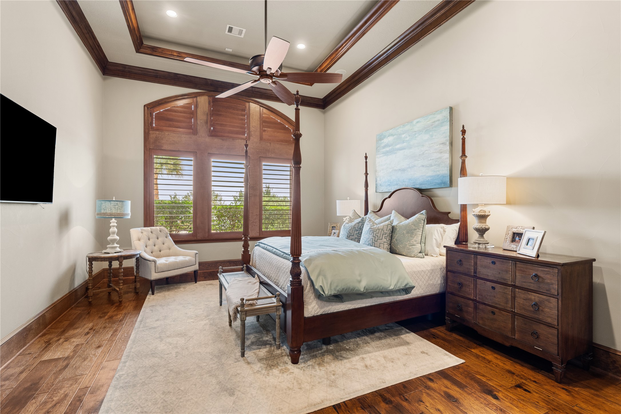 12349 Longmire Trace Conroe, TX 77304 - Photo 13 of 48 Serene primary bedroom retreat featuring tray ceiling, ceiling fan, rich wood trim, and plantation-shuttered windows.