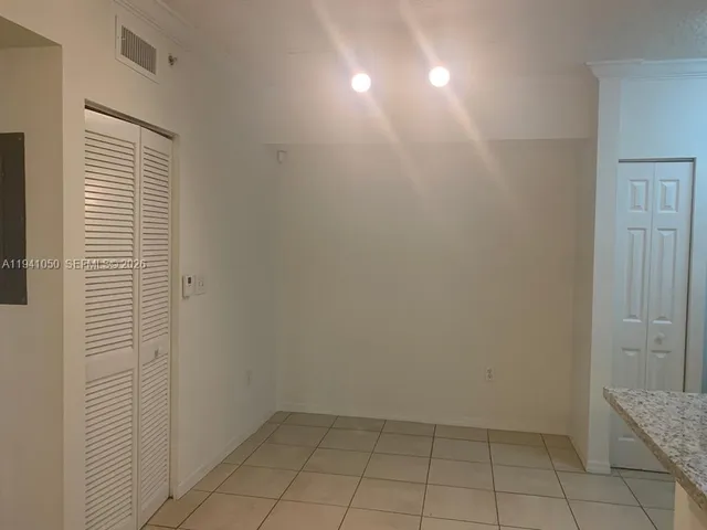 a view of empty room with window and stairs