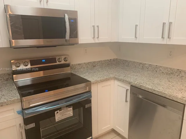 a kitchen with a stove and a microwave