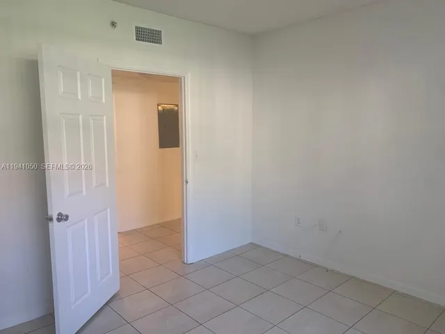 a view of a chandelier fan and entryway