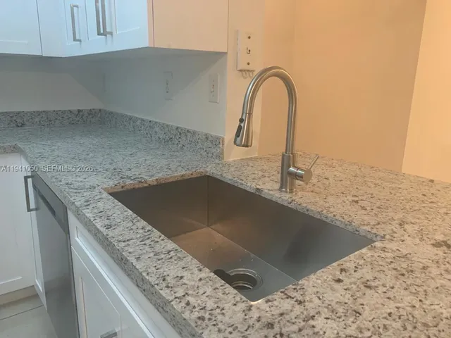 a view of an empty room with bathroom