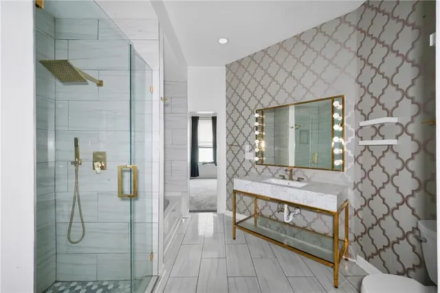 a bathroom with a sink a mirror and shower