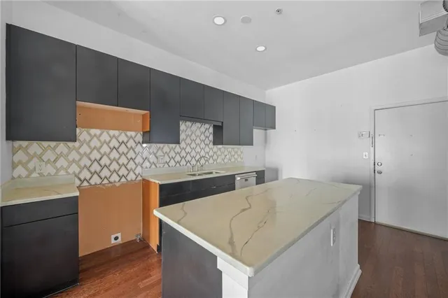 a kitchen with stainless steel appliances a sink and a refrigerator