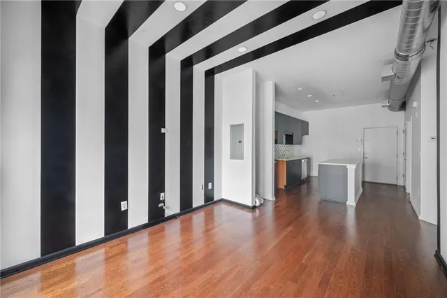 a view of a hallway with wooden floor and staircase