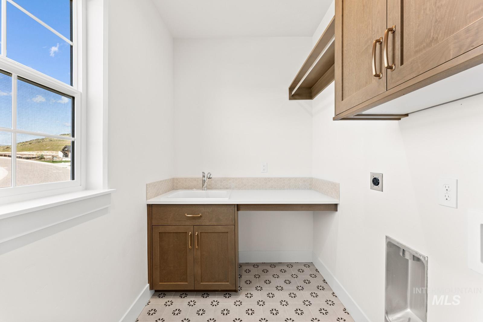 13344 North Spring Creek Way Boise, ID 83714 - Photo 25 of 39 Laundry room with light floors, electric dryer hookup, and cabinet space