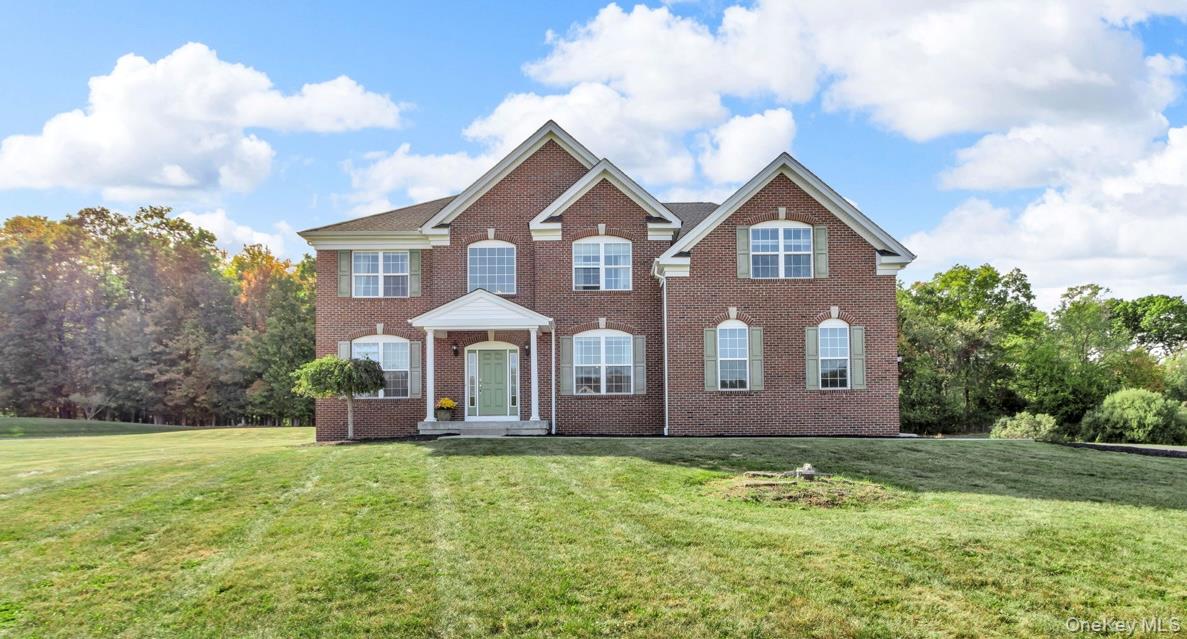 59 Luthien Forrest Road Rock Tavern, NY 12575 - Photo 1 of 1 Colonial home with a front lawn, brick siding