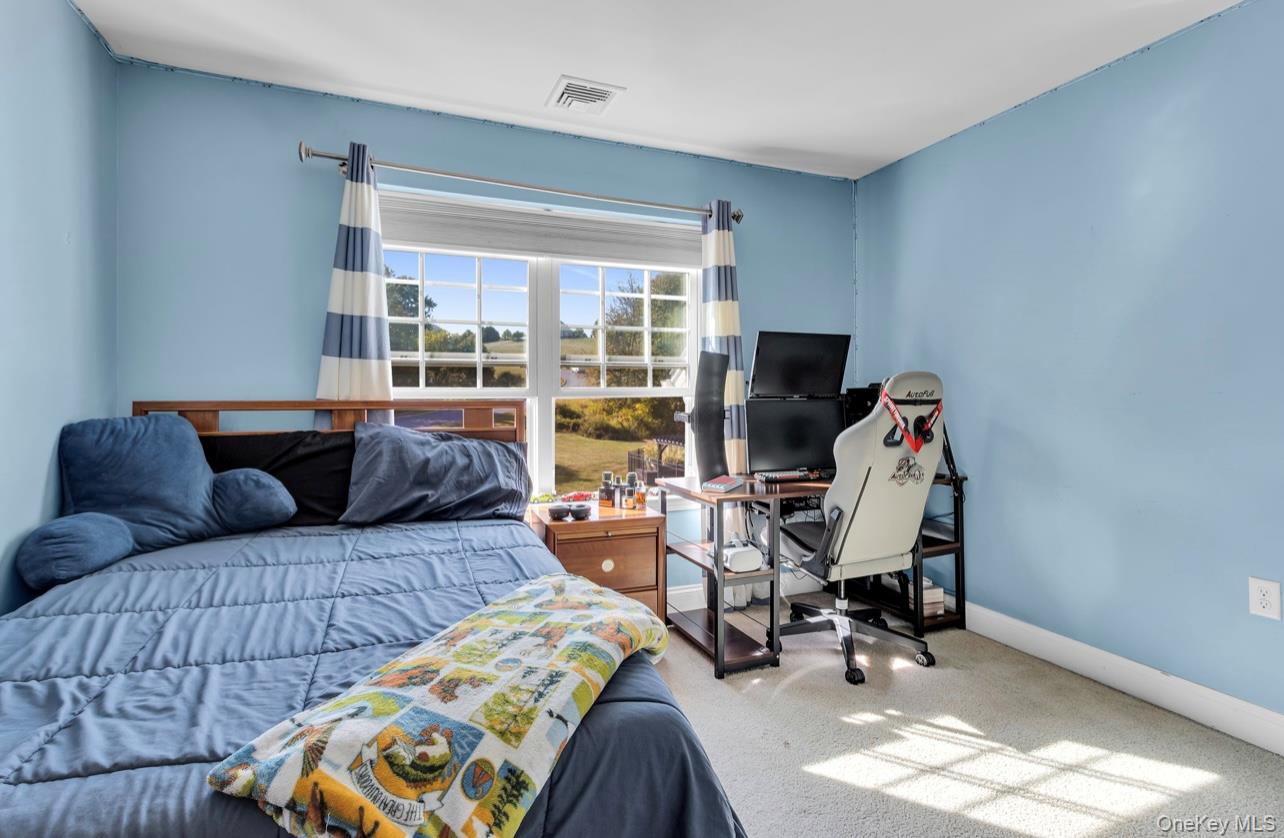 59 Luthien Forrest Road Rock Tavern, NY 12575 - Photo 32 of 48 a living room with furniture a flat screen tv and a large window
